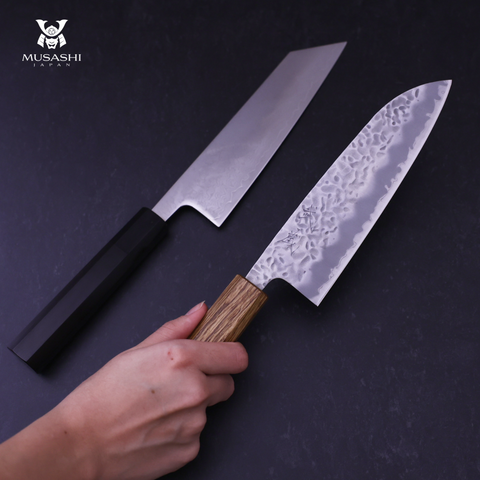 Japanese Kitchen Knives Against A Dark Background